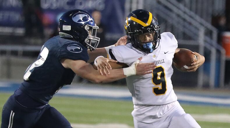 Centerville quarterback Braylon Newcomb is tackled by Fairmont's Gavin Proffitt on a quarterback keeper. BILL LACKEY/STAFF