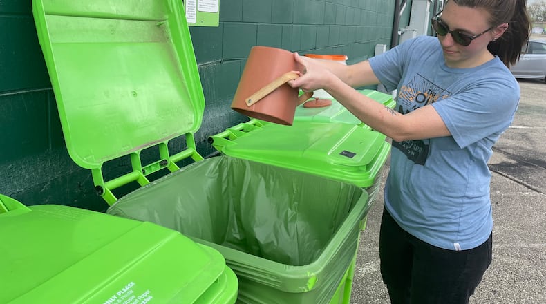 Waste-Free Dayton has teamed up with 2nd Street Market to offer a free, community compost station located on the backside of the market near Webster Street. Pictured is Natalie Warrick, founder and co-executive director of Waste-Free Dayton. NATALIE JONES/STAFF