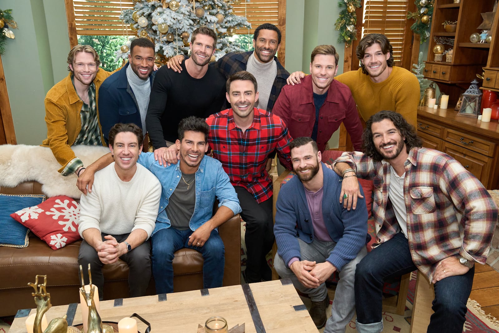 Host Jonathan Bennett and judge Melissa Peterman kick off the hunt for Hallmark’s next leading man as 10 new hunks reinvent Santa, then brave a ski-slope meet-cute with Janel Parrish- where spills steal the scene. Photo: Logan Shephard (top row, far left), Robbie Simpson, Marcus Brodie, Angel Garet, Davey Fisher, Jonathan Bennett, Gabriel Thaxton, Jake Schum, Craig Geoghan, Drake Kuyper, Rustin Sailors  Credit: ©2025 Hallmark Media/Photographer: Kim Nunneley