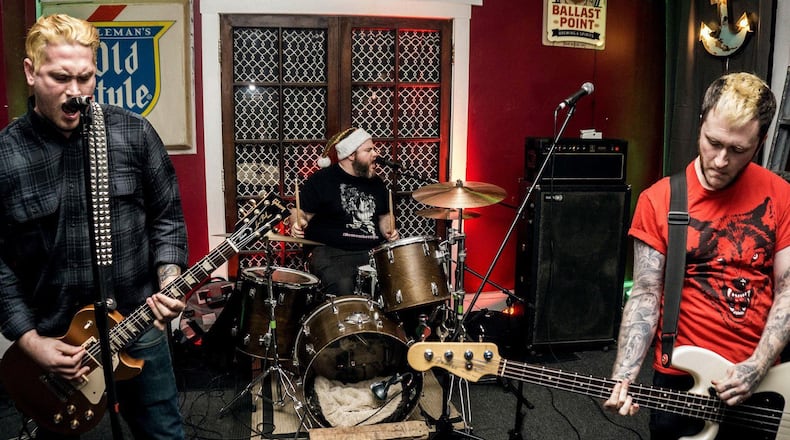 The Raging Nathans, (left to right) Josh Goldman, Nick Hamby and Jared Rey nolds, celebrate the release of the new album, Cheap Fame, at Blind Bob s in Dayton on Friday, Feb. 2. CONTRIBUTED