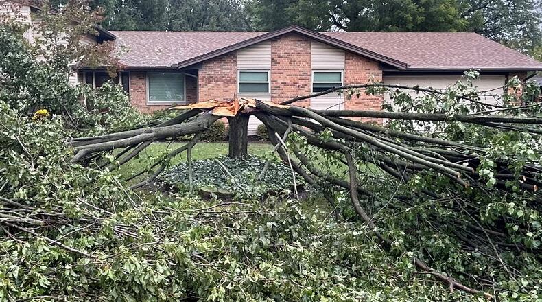 A tree at a home on Hyde Park Drive in Centerville was split into two Friday night, Sept. 27, 2024 after winds from remnants of Hurricane Helene swept through the area. Jeremy Kelley/Staff photo