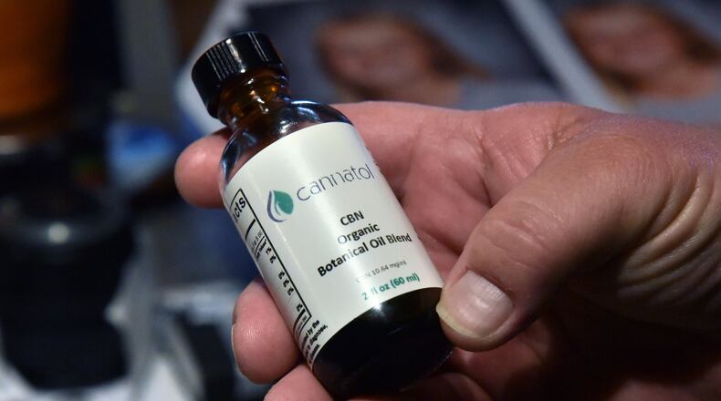 Jim “J-Bo” Wages holds a bottle of cannabis oil for her daughter Sydney at their home in Dallas on Wednesday, February 8, 2017. The family was among the very first to receive permission from Georgia to use low-dose cannabis oil without fear of prosecution. HYOSUB SHIN / HSHIN@AJC.COM