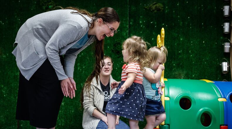 Piqua Christian Preschool and Childcare teacher McKenzie Neer (left) interacts with the kids at the school during the summer. Jim Noelker/Staff