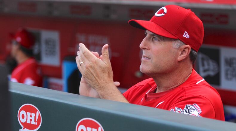Reds manager Bryan Price claps during a ceremony honoring Scooter Gennett on Friday, June 16, 2017, at Great American Ball Park in Cincinnati. David Jablonski/Staff