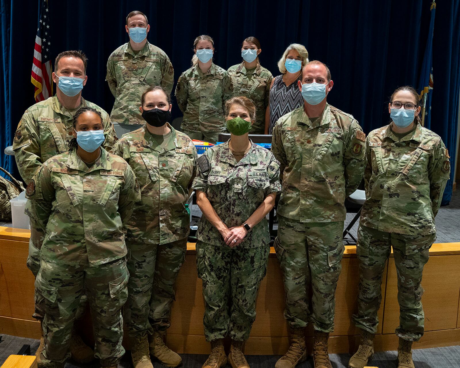 Rear Adm. Kristen Fabry (center), Defense Logistics Agency Land and Maritime commander, poses Oct. 1 with a group of 88th Medical Group Airmen during a visit to Wright-Patterson Medical Center. The Airmen were part of a team that traveled to Columbus earlier this year to administer COVID-19 vaccines to DLA members in Fabry’s command, and she wanted to personally thank them. U.S. AIR FORCE PHOTO/R.J. ORIEZ