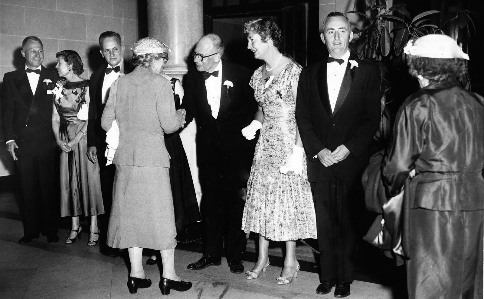 Guests are greeted by Tom Colt, (center) the director of the Dayton Art Institute at the first Junior League holiday ball held at the Dayton Art Institute in 1957. The event, now known as Art Ball, is marking its 60th year. DAYTON DAILY NEWS ARCHIVE