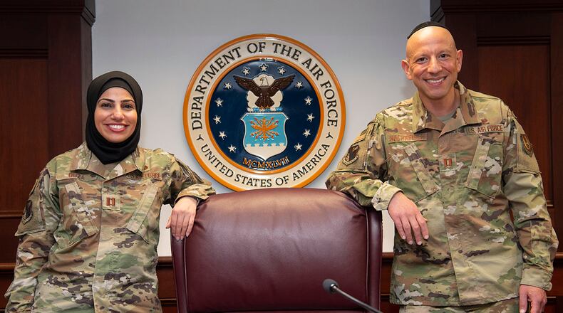 Capt. Maysaa Ouza (left), 88th Air Base Wing chief of adverse actions, and Capt. Yosef Hochheiser, Air Force reservist and 88 ABW assistant staff judge advocate, are pictured in the U.S. courtroom at Wright-Patterson Air Force Base on May 20. Their partnership helped establish the first religious-accommodation rule change for Muslims to wear a hijab in uniform. U.S. AIR FORCE PHOTO/R.J. ORIEZ