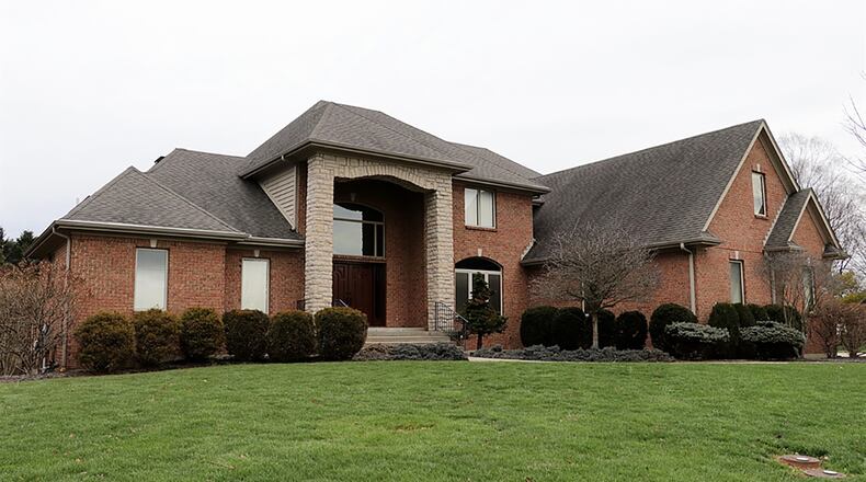 The brick 2-story with about 7,215 sq. ft. of living space has a first-floor main bedroom, a finished walk-out basement with recreation room, family room and 3 bonus rooms. CONTRIBUTED PHOTO BY KATHY TYLER