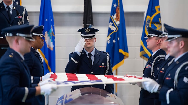 New members of the Wright-Patterson Air Force Base Honor Guard demonstrate a six-man flag-fold during their graduation ceremony on April 25. Guardsmen demonstrated the full funeral service, including gun salute and taps, prior to receiving their honor guard badges. U.S. AIR FORCE PHOTO/R.J. ORIEZ