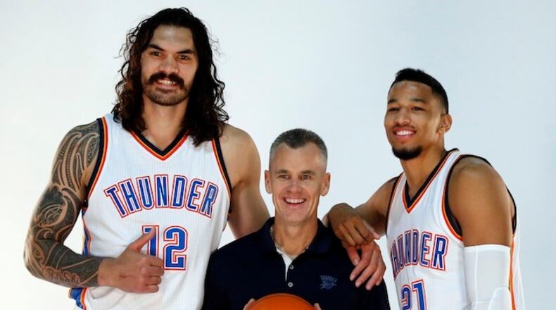 Oklahoma City Thunder head coach Billy Donovan, center, poses for a photo with center Steven Adams, left, and guard Andre Roberson, right, during the 2016-2017 Oklahoma City Thunder Media Day in Oklahoma City, Friday, Sept. 23, 2016. (AP Photo/Sue Ogrocki)