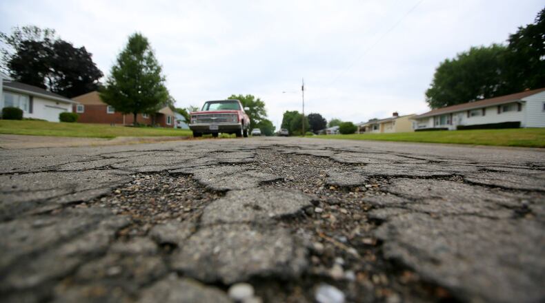 The city of Middletown expects to receive one-time revenue windfalls of $1 million to $2 million in coming years from construction projects. Two options for the money are investment in the East End/Renaissance area near Interstate 75 and Ohio 122, or fix older crumbling streets like Hannah Dr., shown here. GREG LYNCH / STAFF