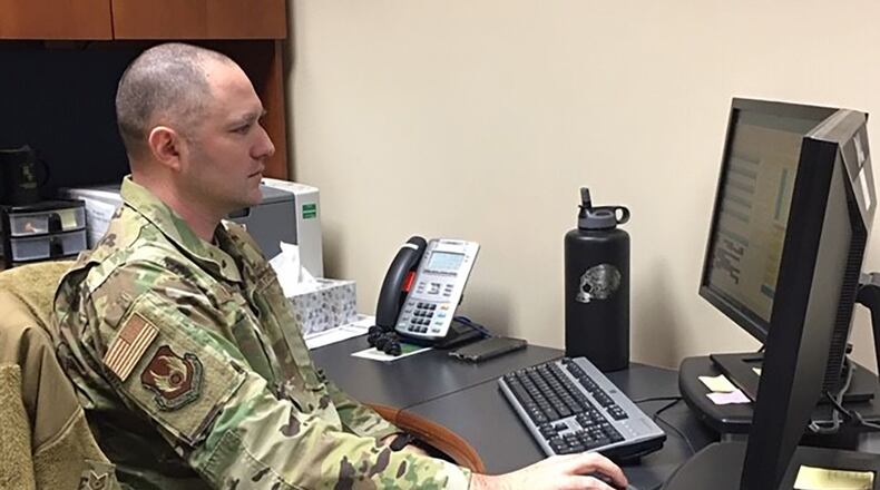 Tech. Sgt. Gregory Linker, 88th Air Base Wing Military Personnel Flight section chief, Career Development, observes permanent change of station processing practices, percentages and customer service data to make processes lean and timely. (U.S. Air Force photo/Kimberly Gaither)