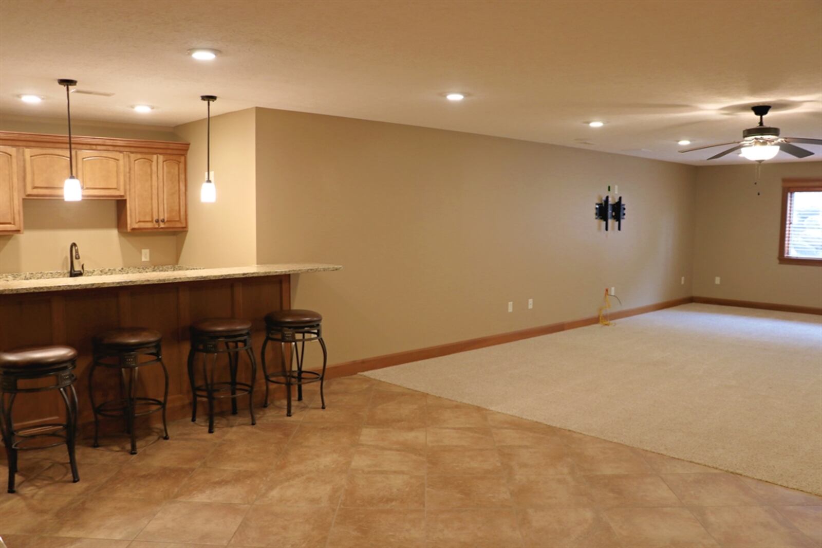 Three daylight windows fill the lower-level media room with plenty of natural light.