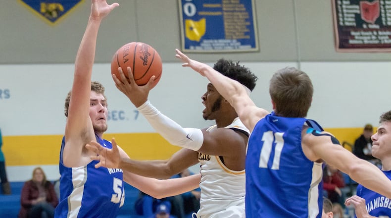 Springfield High School junior Larry Stephens drives against Miamisburg’s Duncan Hall during the Wildcats’ 36-31 victory in their home opener against Miamisburg on Friday, Dec. 7, 2018. MICHAEL COOPER / CONTRIBUTED