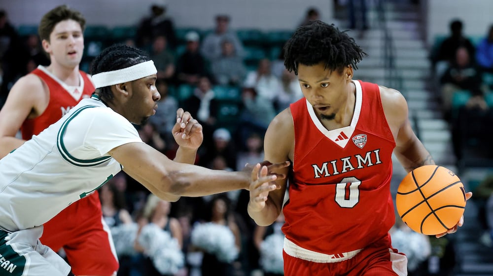 Miami (OH) forward Eian Elmer (0) drives to the basket against Eastern Michigan guard Gregory Lawson, left, during the first half of an NCAA college basketball game Tuesday, Feb. 24, 2026, in Ypsilanti, Mich. (AP Photo/Duane Burleson)