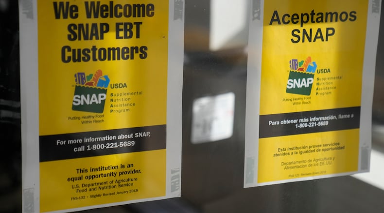 Signage showing that USDA Supplemental Nutrition Assistance Program (SNAP) is accepted, is displayed at Wild Onion Market, Monday, Oct. 27, 2025, in Chicago. (AP Photo/Erin Hooley)