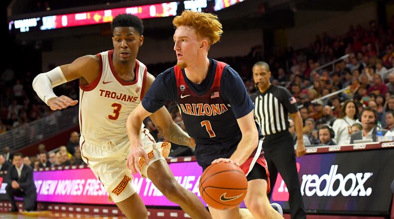 USC's Elijah Weaver, left, Arizona's Nico Mannion as he drives to the basket in the first half of the game at Galen Center on February 27, 2020 in Los Angeles, California. (Photo by Jayne Kamin-Oncea/Getty Images)