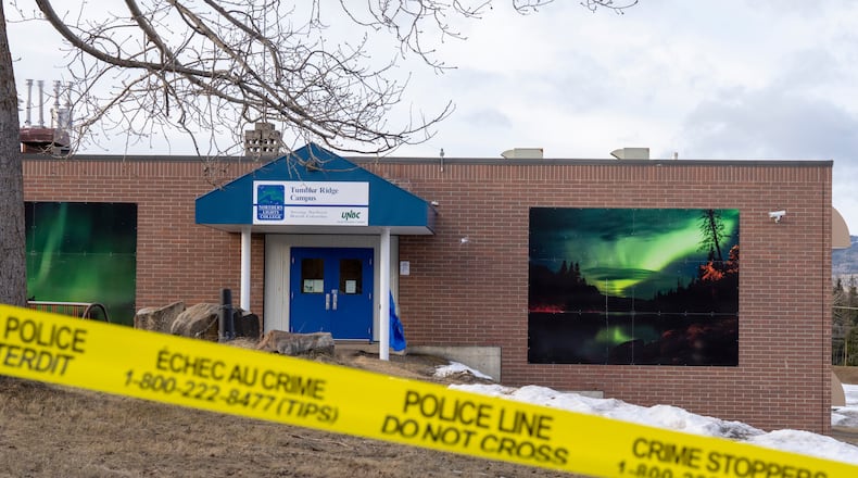 Police tape surrounds a school in Tumbler Ridge, British Columbia, Canada, on Thursday, Feb. 12, 2026, after Tuesday's mass shooting. (Christinne Muschi/The Canadian Press via AP)