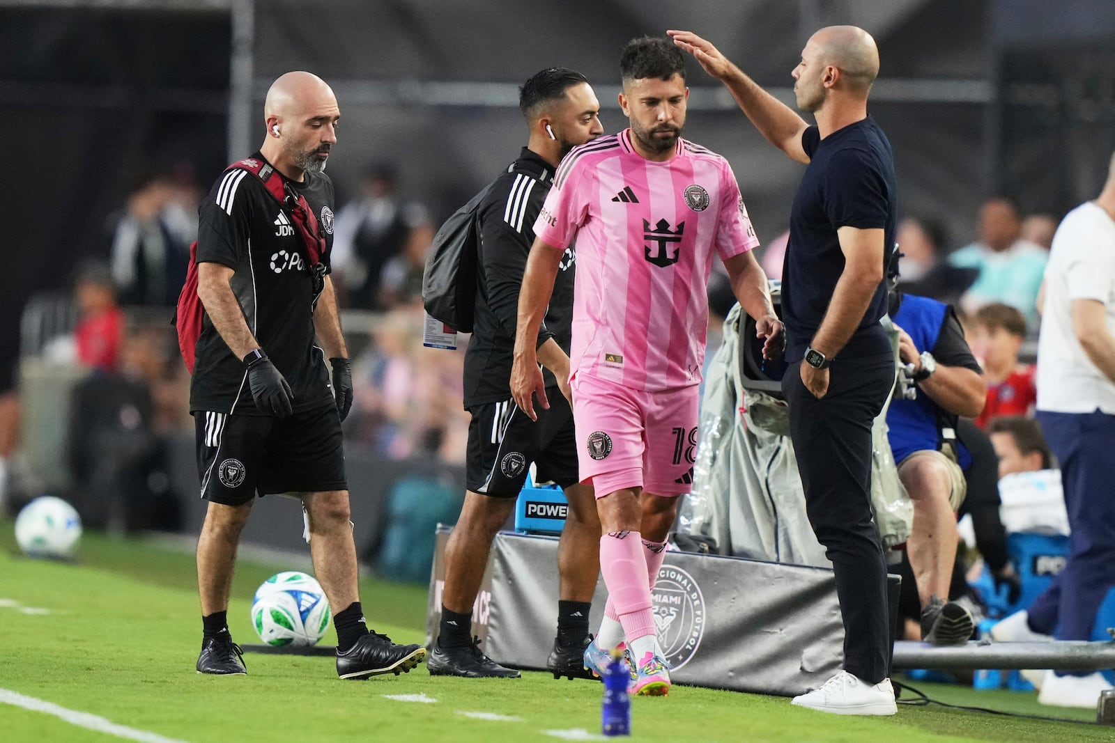 Inter Miami midfielder Jordi Alba, second from right, is patted on the head by head coach Javier Mascherano, right, as he leaves the game with an injury during the first half of an MLS soccer match against CF Montreal, Wednesday, May 28, 2025, in Fort Lauderdale, Fla. (AP Photo/Lynne Sladky)