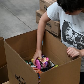 Pictured are volunteers at Shared Harvest Foodbank in Fairfield, Ohio, on Wednesday, July 9, 2025, packaging food in preparation for distribution. The federal cut to Supplemental Nutrition Assistance Program, or SNAP, benefits with the passage of the so-called "One Big Beautiful Bill" approved by Congress and signed by President Donald Trump, organizations like Shared Harvest expect to see an increase in clients as federal food supplies decrease. "Our greatest concern is that we continue in the pattern of reducing food sources, and we continue to see growing numbers of people coming to our network,” said Shared Harvest Executive Director Terry Perdue. “It’s less food and more people needing access to charitable food.” MICHAEL D. PITMAN/STAFF