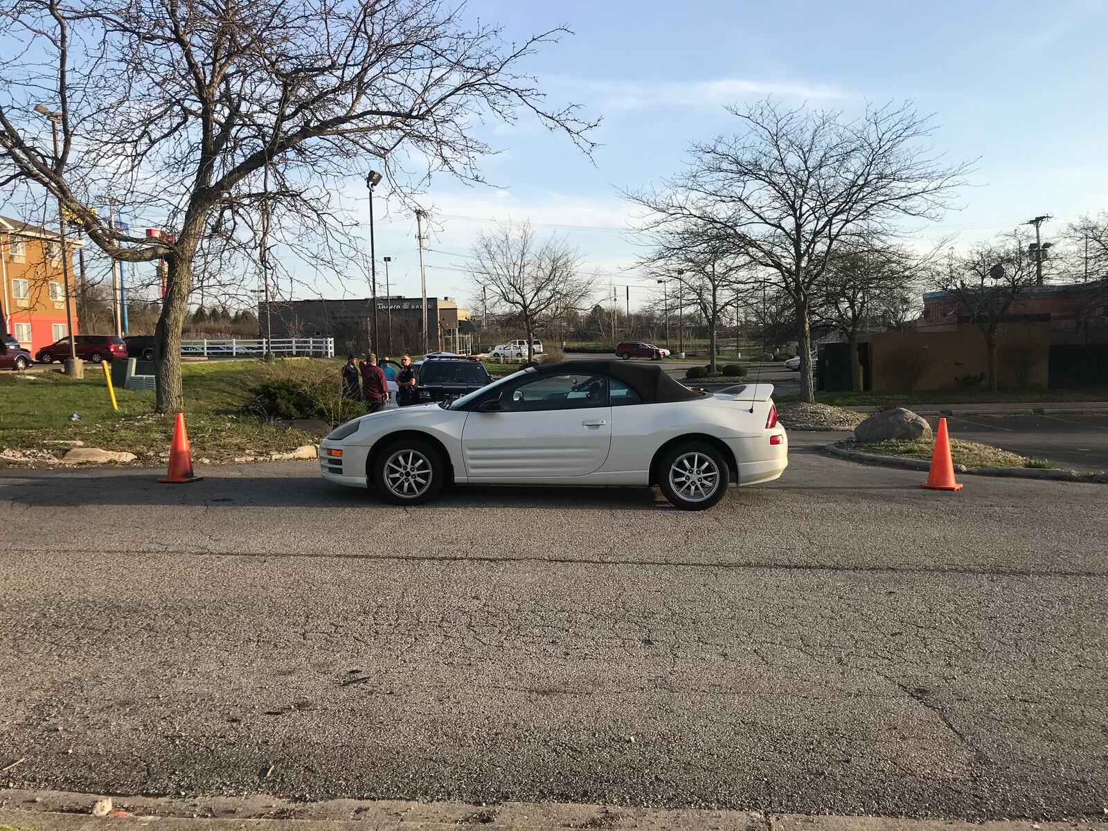 Baymont Inn owner Khalid Chaudhry used his car to block the driveway off Old Troy Pike on Thursday night, April 12, 2018, that leads to Osaka Japanese Steakhouse and Panera Bread. (Jessica Weihrauch/Staff)
