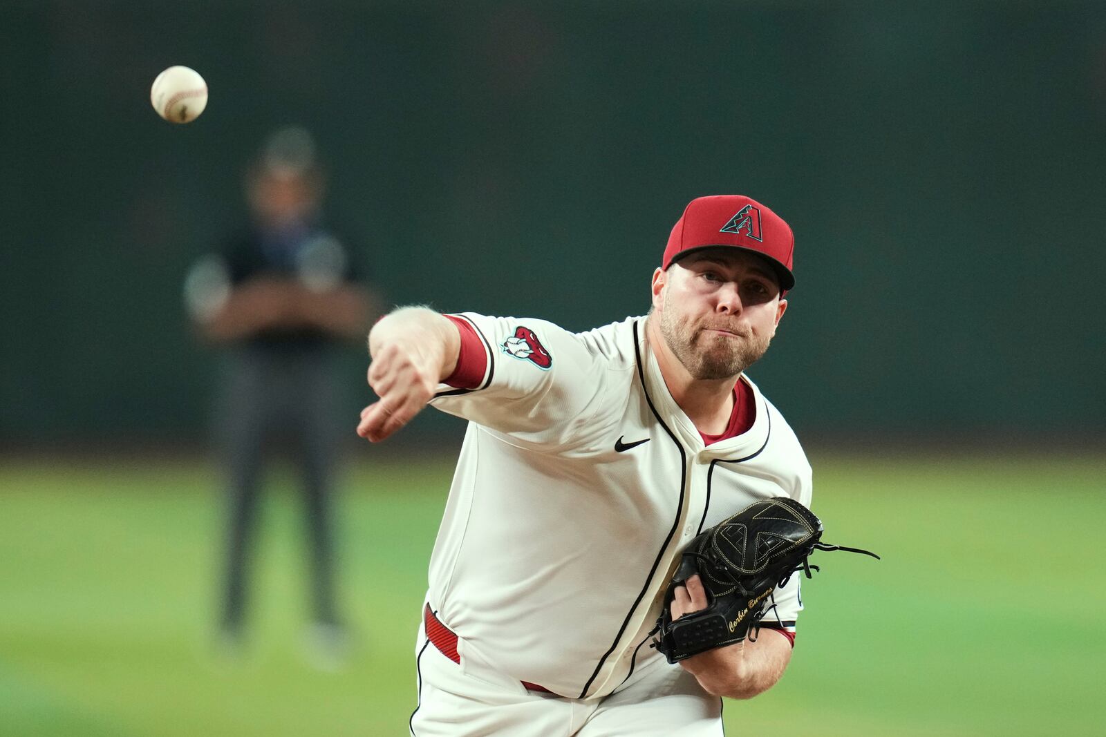 Arizona Diamondbacks starting pitcher Corbin Burnes warms up prior to a baseball game against the Pittsburgh Pirates Tuesday, May 27, 2025, in Phoenix. (AP Photo/Ross D. Franklin)