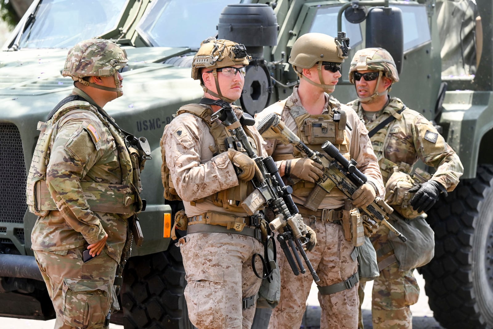 U.S Marines work next to members of the California National Guard outside of a federal building, Friday, June 13, 2025, in Los Angeles (AP Photo/Noah Berger)
