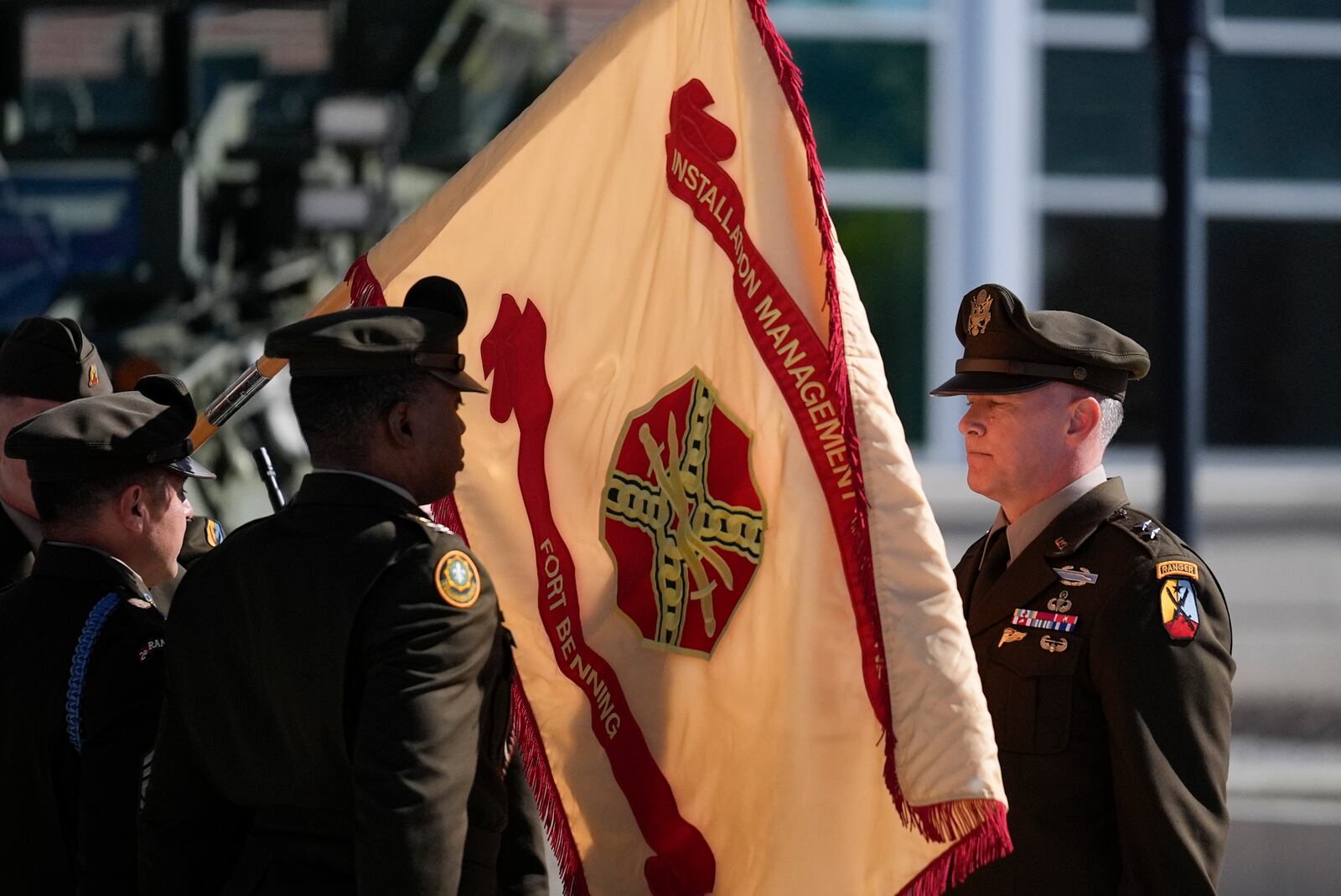 Members of the Army military change a flag from Fort Moore to Fort Benning during a ceremony at Fort Benning, honoring new namesake of World War I Fred Benning on Wednesday, April 16, 2025, in Fort Benning, Ga. (AP Photo/Brynn Anderson)