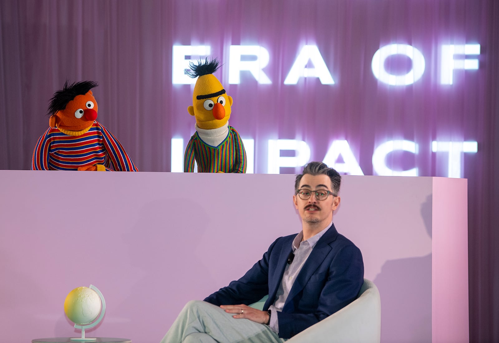 Sesame Street's Bert and Ernie speak with Sal Perez, executive producer and VP of Sesame Street at Sesame Workshop, after Sesame Workshop won the Elevate Prize Foundation's Catalyst Award, Wednesday, May 14, 2025, in Miami Beach, Fla. (AP Photo/Michael Laughlin)