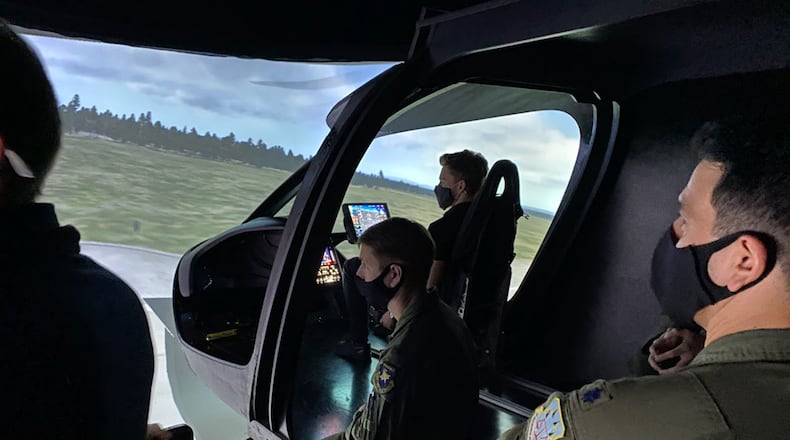 Air Force operators and engineers assess the BETA Technologies ALIA flight simulator. COURTESY PHOTO/BETA TECHNOLOGIES