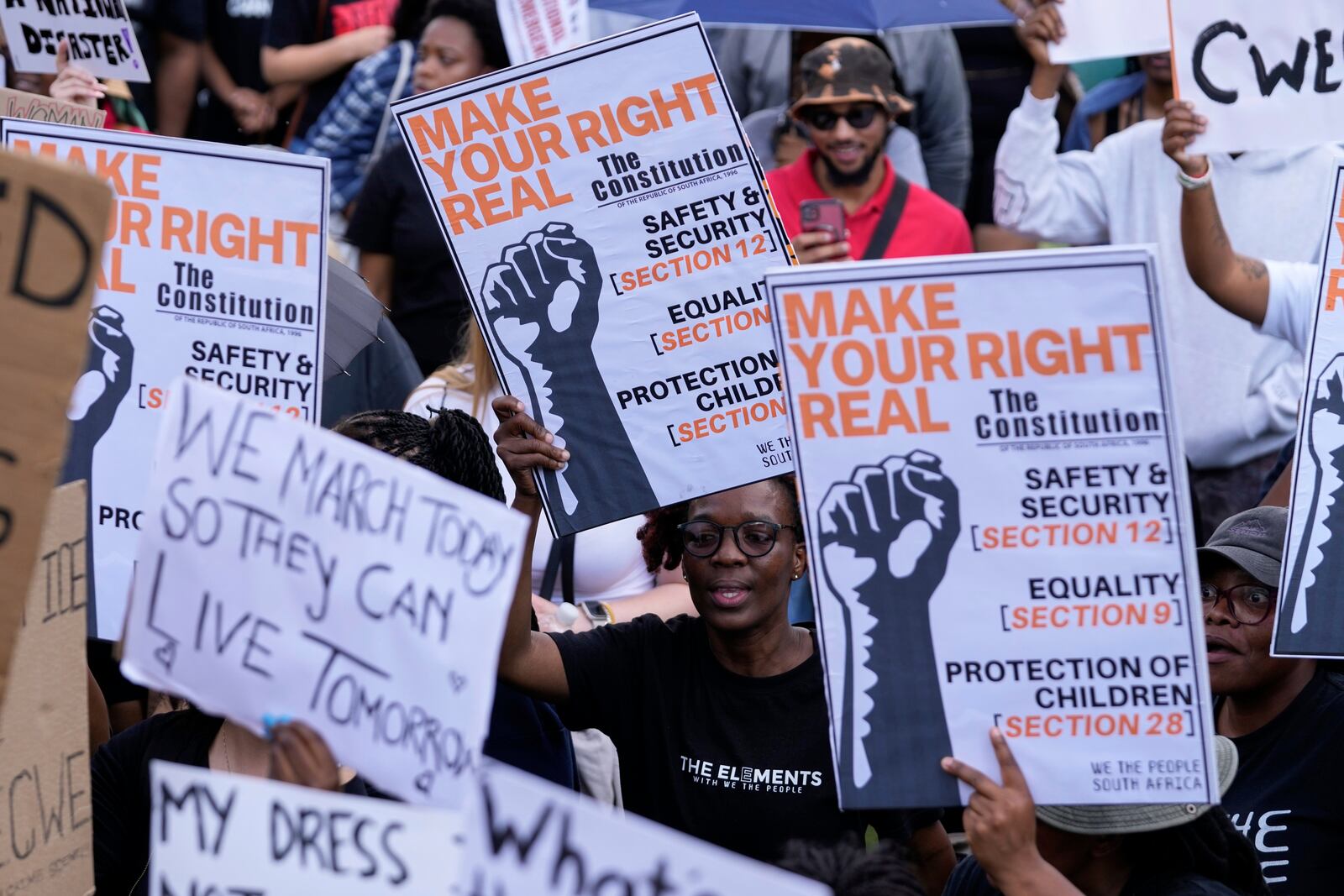 Activists chant slogans as they hold placards during the women's protest and hand over of a petition demanding that gender-based violence and femicide be declared a national disaster, at the Union Buildings in Pretoria, South Africa, Friday, April 11, 2025. (AP Photo/Themba Hadebe)
