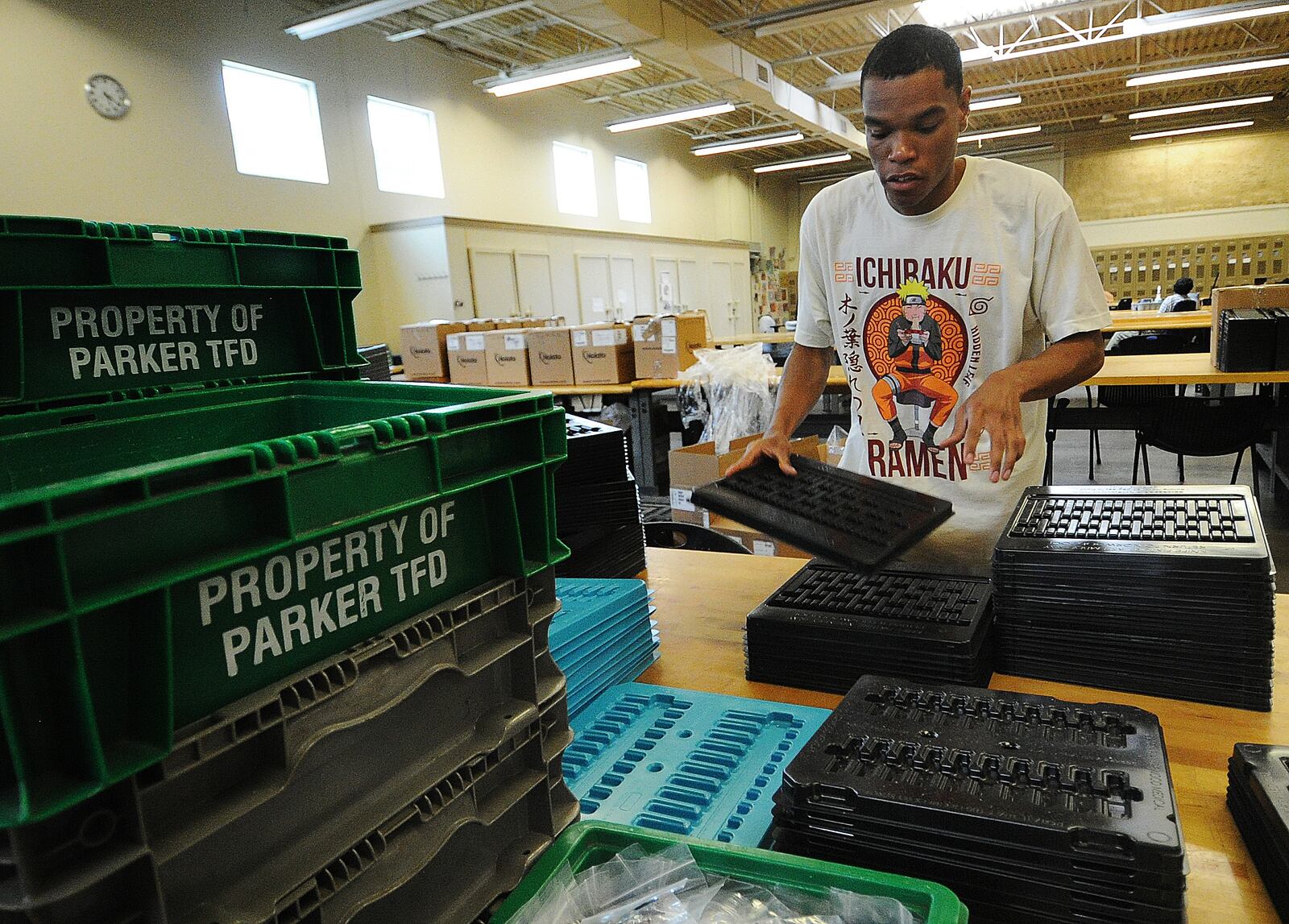 Damien, a worker at Better Living Home Health, stacks plastic trays that will be boxed and shipped away for a company. He is paid through the federal 14c program. MARSHALL GORBY\STAFF