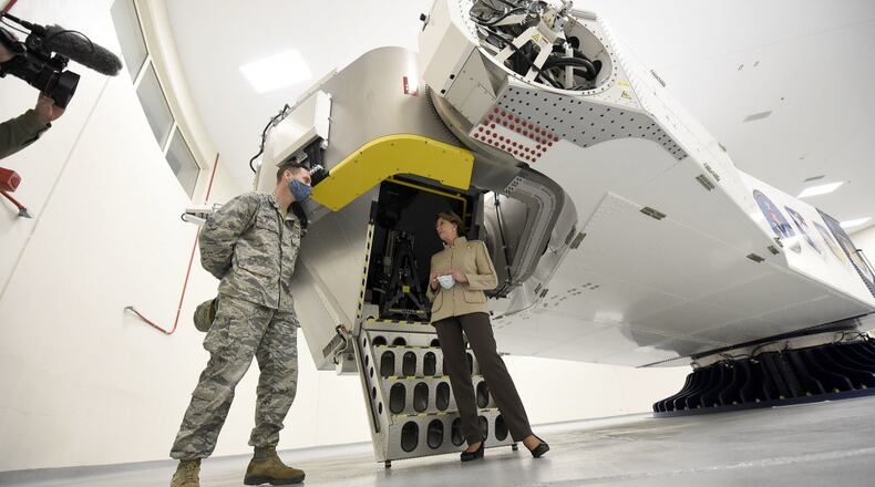 Secretary of the Air Force Barbara Barrett stands by the centrifuge used by the U.S. Air Force School of Aerospace Medicine, shown to her at Wright-Patterson Air Force Base Tuesday. Barrett met with Air Force personnel and toured facilities at the base including the U.S. Air Force School of Aerospace Medicine Epidemiology Laboratory, which is responsible for analyzing a majority of the COVID-19 tests in the Air Force. (U.S. Air Force photo by Ty Greenlees)