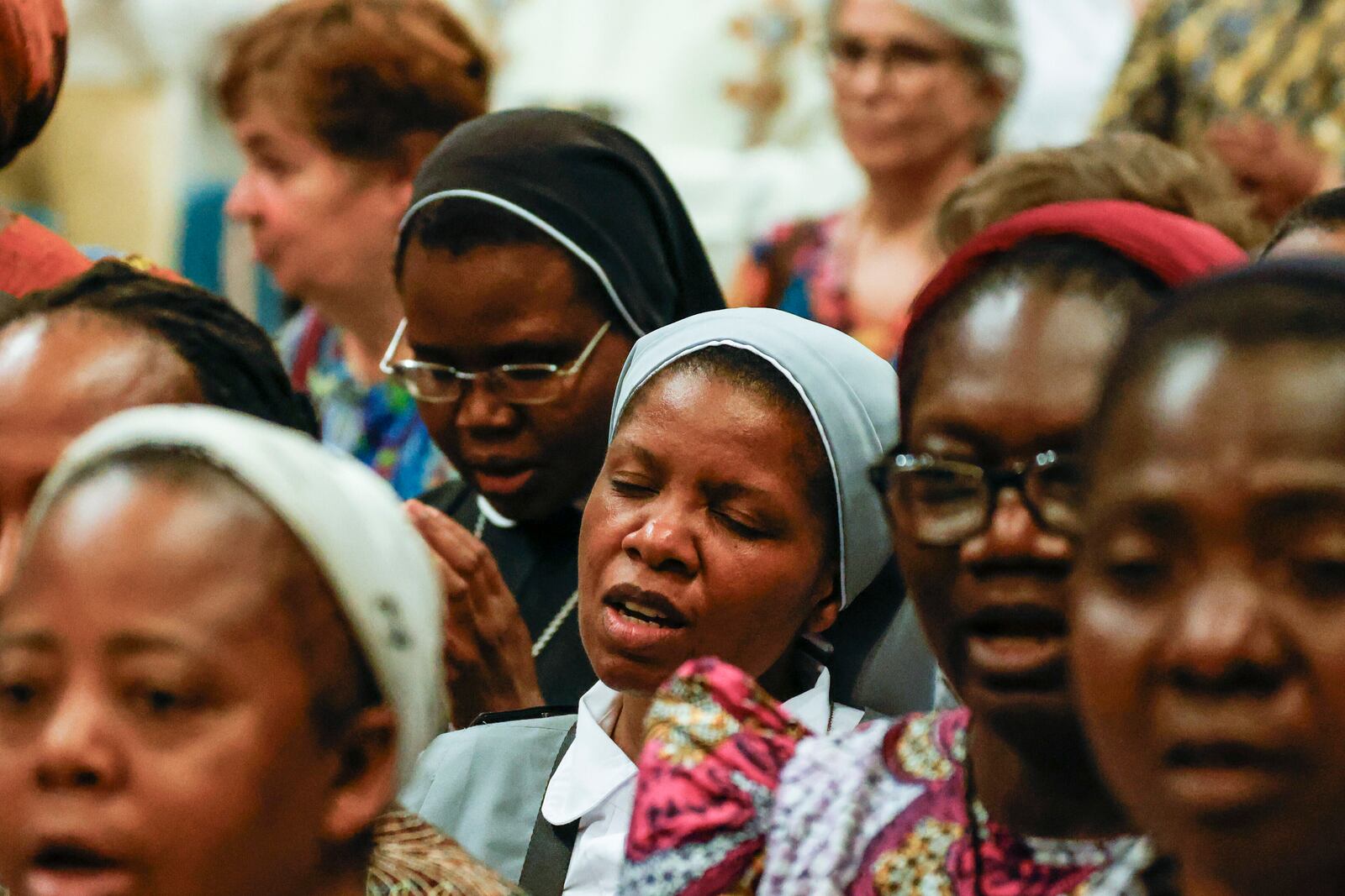 Faithful pray during a ceremony for the beatification of Floribert Bwana Chui Bin Kositi, a Congolese man killed in 2007 for fighting corruption, in St. Paul Outside the Walls' Basilica, in Rome, Sunday, June 15, 2025. (AP Photo/Riccardo De Luca)