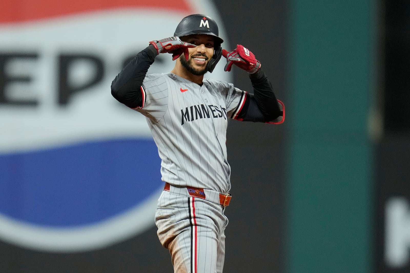 Minnesota Twins' Carlos Correa (4) gestures at second base after hitting a double in the fourth inning of a baseball game against the Cleveland Guardians in Cleveland, Tuesday, April 29, 2025. (AP Photo/Sue Ogrocki)