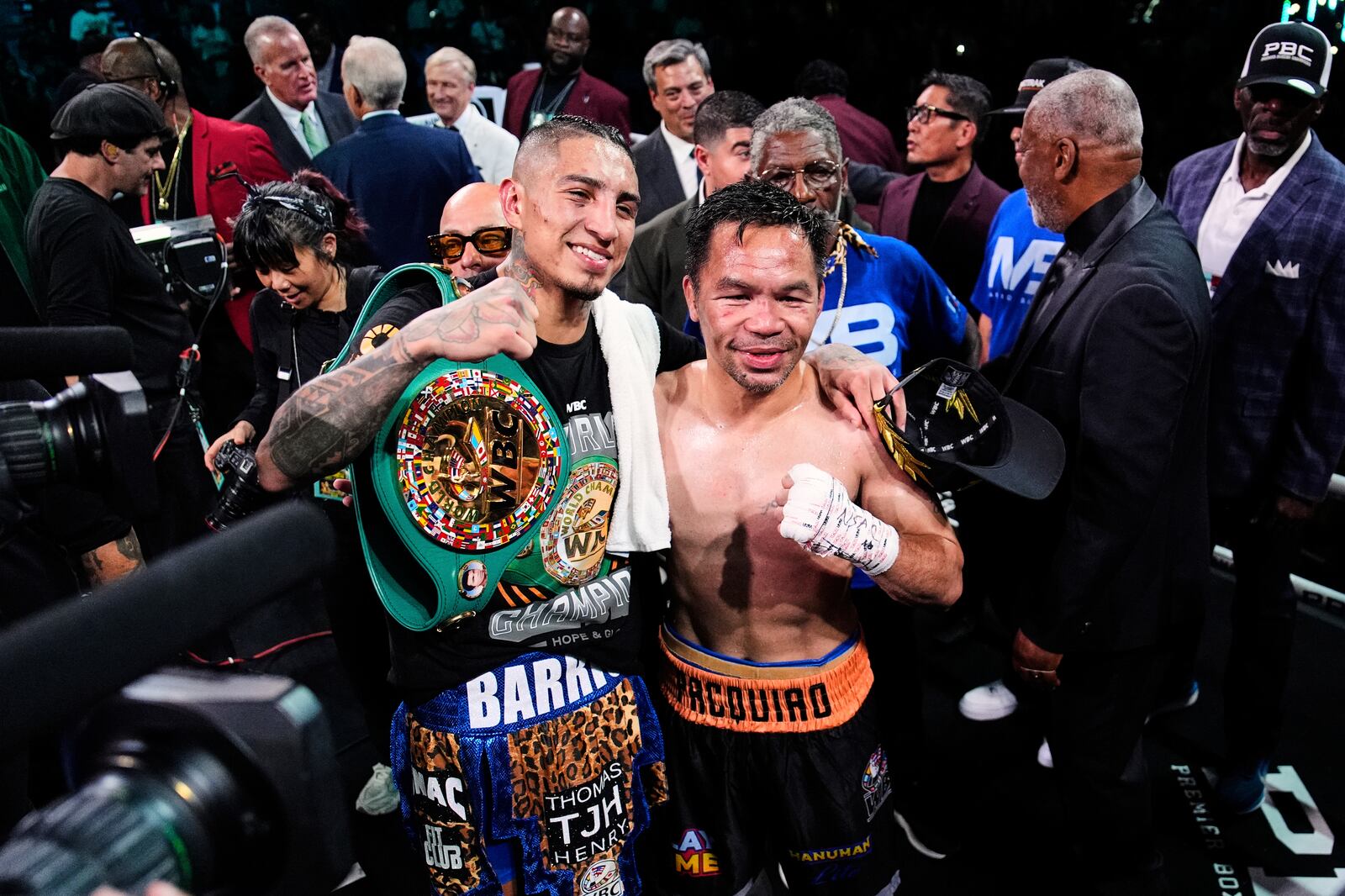 Mario Barrios, left, and Manny Pacquiao one for a photo after fighting to a majority draw in a welterweight title boxing match Saturday, July 19, 2025, in Las Vegas. (AP Photo/John Locher)