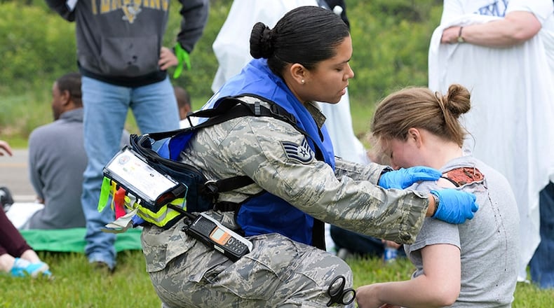 Staff Sgt. Jhosselin Alonzo, 88th Medical Operations Squadron paramedic, triages Airman 1st Class Chloe Ingram, National Air and Space Intelligence Center scientific applications technician, during a mass-casualty exercise at Wright-Patterson Air Force Base on May 5, 2016. U.S. AIR FORCE PHOTO/WESLEY FARNSWORTH