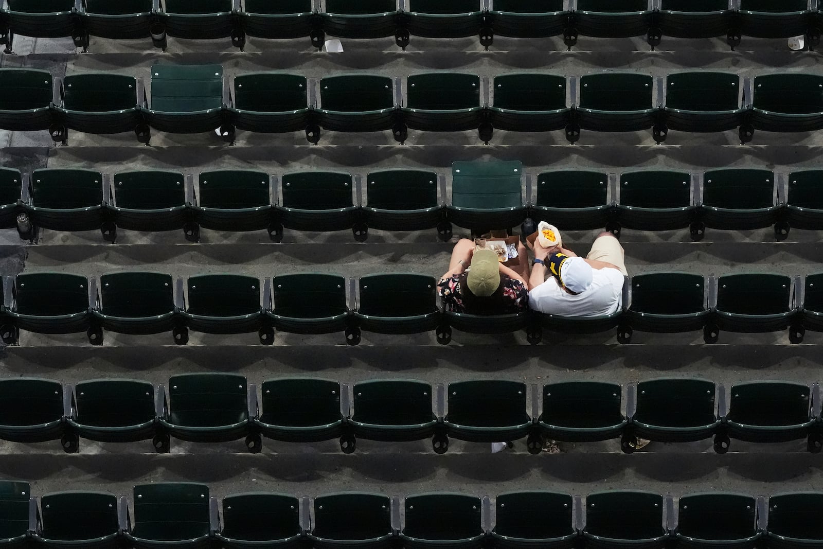 Baseball fans wait during a rain delay before a baseball game between the Cleveland Guardians and the Chicago White Sox in Chicago, Thursday, July 10, 2025. (AP Photo/Nam Y. Huh)