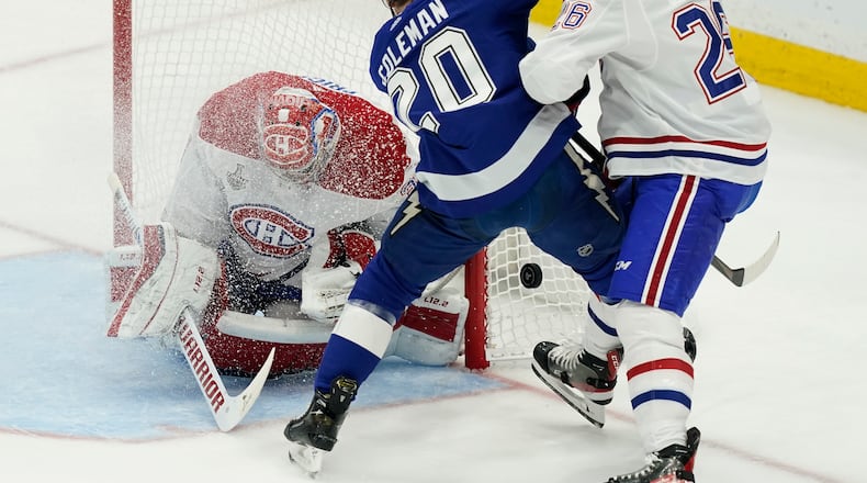 Montreal Canadiens defenseman Jeff Petry (26) checks Tampa Bay Lightning center Blake Coleman (20) next to Canadiens goaltender Carey Price (31) during the first period in Game 5 of the NHL hockey Stanley Cup finals, Wednesday, July 7, 2021, in Tampa, Fla. (AP Photo/Gerry Broome)