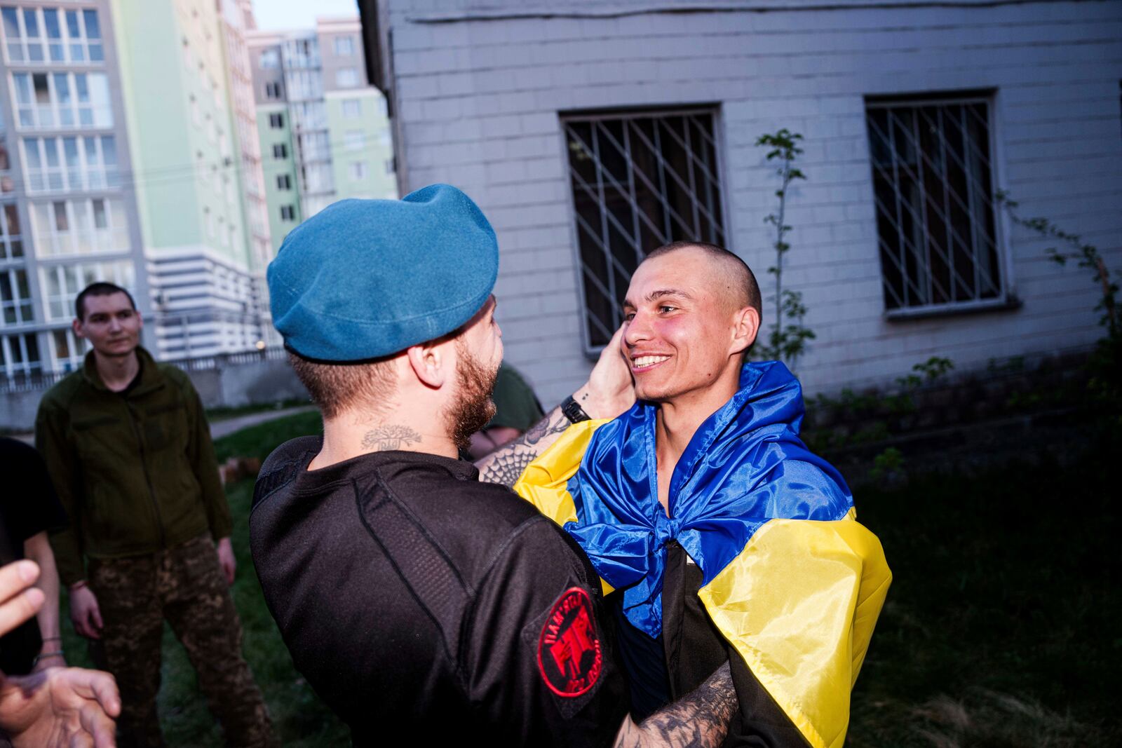 A Ukrainian soldier hugs his comrade after returning from captivity in a POW exchange in Ukraine, on Saturday, April. 19, 2025. (AP Photo/Evgeniy Maloletka)