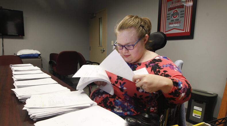 Theresa Sauter, 29, of Centerville receives a number of services funded by the Montgomery County Human Services Levy that helps integrate her into the community, allows her to live with a degree of independence and gives her employment opportunities such as the clerical job at Watson’s she’s held for nine years. CHRIS STEWART / STAFF