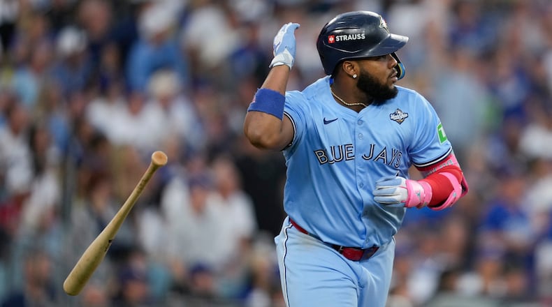 Toronto Blue Jays' Vladimir Guerrero Jr. flips his bat after hitting a two run against the Los Angeles Dodgers during the third inning in Game 4 of baseball's World Series, Tuesday, Oct. 28, 2025, in Los Angeles. (AP Photo/Ashley Landis)