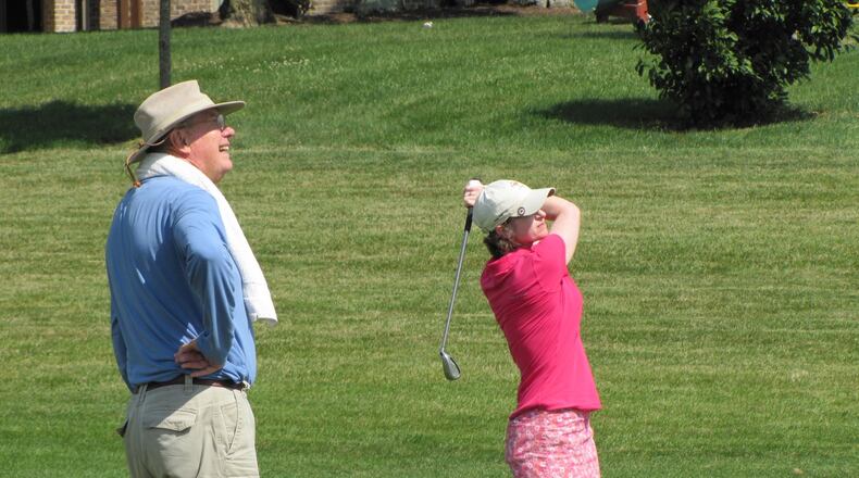 Christine Lindsey and her late father, Jim Ridenour, who would caddy for her at big tournaments. CONTRIBUTED