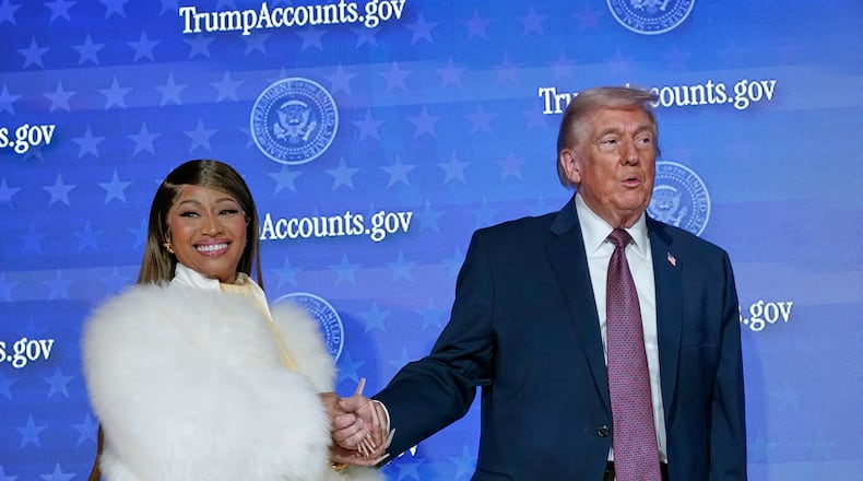 Nicki Minaj and President Donald Trump stand on stage together during an event for "Trump Accounts" at Carnegie Mellon Auditorium, Wednesday, Jan. 28, 2026, in Washington. (AP Photo/Jose Luis Magana)