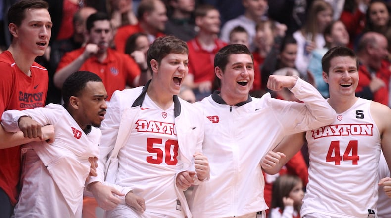 Dayton players cheer on the bench after a dunk by Kostas Antetokounmpo against George Washington on Saturday, March 3, 2018, at UD Arena. David Jablonski/Staff