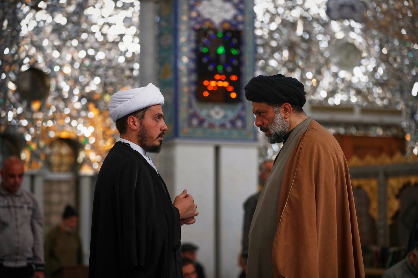 Shiite clergy speak at the Sayyida Zeinab Shrine, where many Shiite Muslims believe Zeinab, the granddaughter of Prophet Muhammad, is entombed, in Sayyida Zeinab, south of Damascus, Syria, Saturday, March 15, 2025. (AP Photo/Omar Sanadiki)