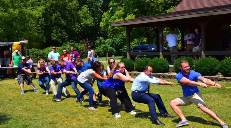 Financial management and contracting interns battle it out with program management interns in a friendly challenge of tug of war at the inaugural Wright-Patterson Air Force Base picnic held at Bass Lake Aug. 10. The PM interns were victorious. (U.S. Air Force photo/Alex Feuling)