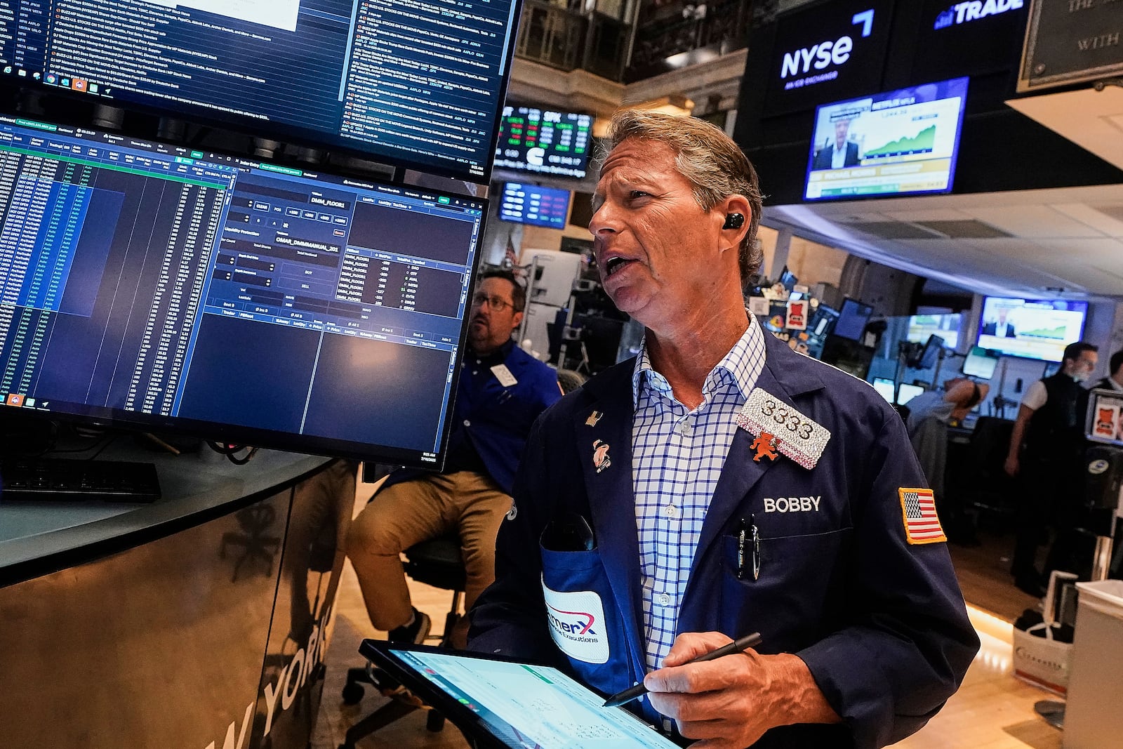 Trader Robert Charmak works on the floor of the New York Stock Exchange, Friday, July 18, 2025. (AP Photo/Richard Drew)