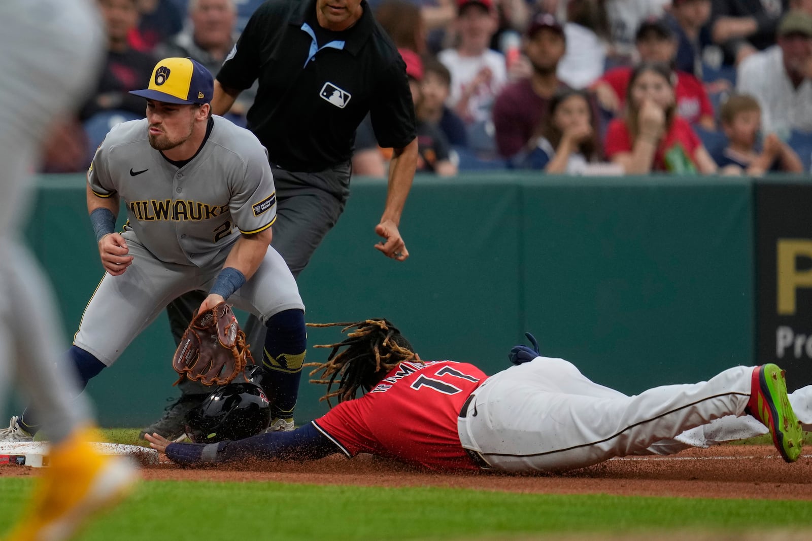 Cleveland Guardians' Jose Ramirez, right, steals third base as Milwaukee Brewers third baseman Caleb Durbin, left, waits for the throw in the fourth inning of a baseball game in Cleveland, Monday, May 12, 2025. (AP Photo/Sue Ogrocki)