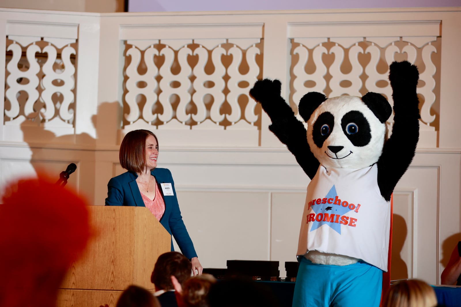 Robyn Lightcap, executive director at Preschool Promise, looks on as a panda mascot hypes up the crowd at the Excellence in Early Education Awards held Thursday, Sept. 29. Courtesy of Preschool Promise.